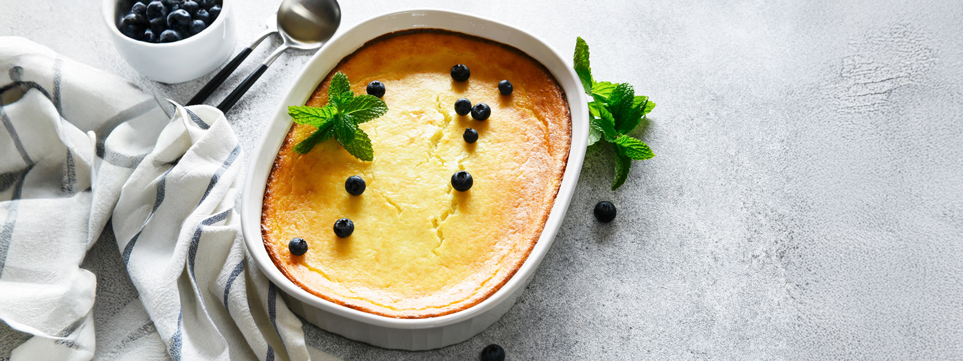teglia con budino di ricotta cotto al forno e mirtilli sparsi
